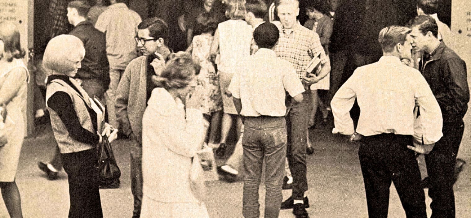 People socializing at a vintage gathering, historical black-and-white photo capturing community events, news, and music heritage, reflective of past daily life and cultural archives.