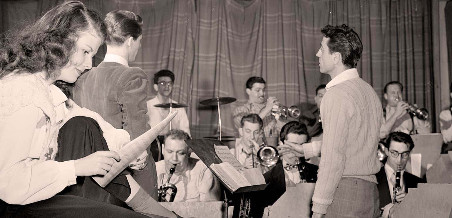 Victory orchestra jazz band rehearsing 1950s black and white photo music archive vintage radio broadcast.