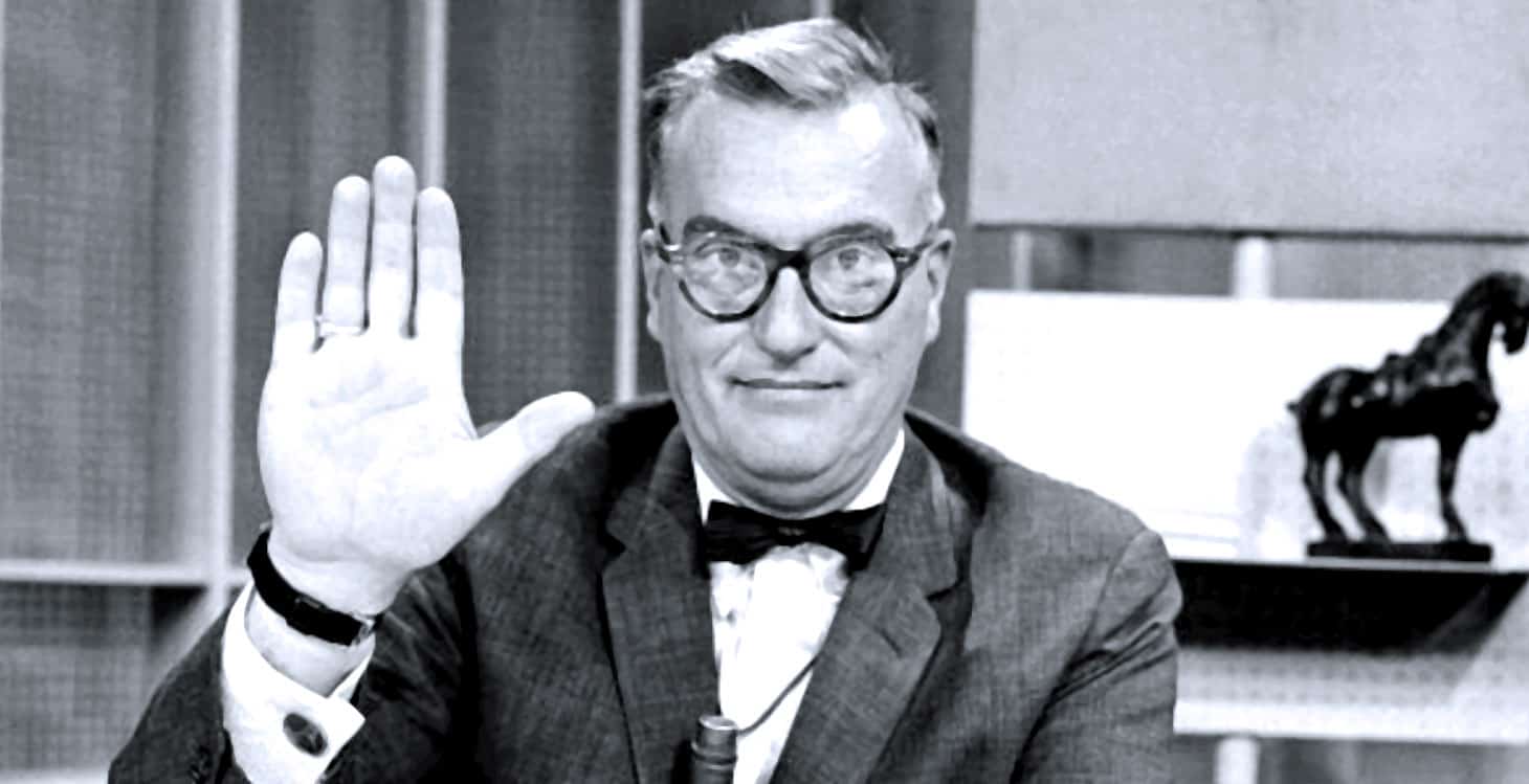 Retro black and white image of a smiling man with glasses and a bow tie waving, in a vintage radio or news studio setting, representing historical news and music broadcasting.