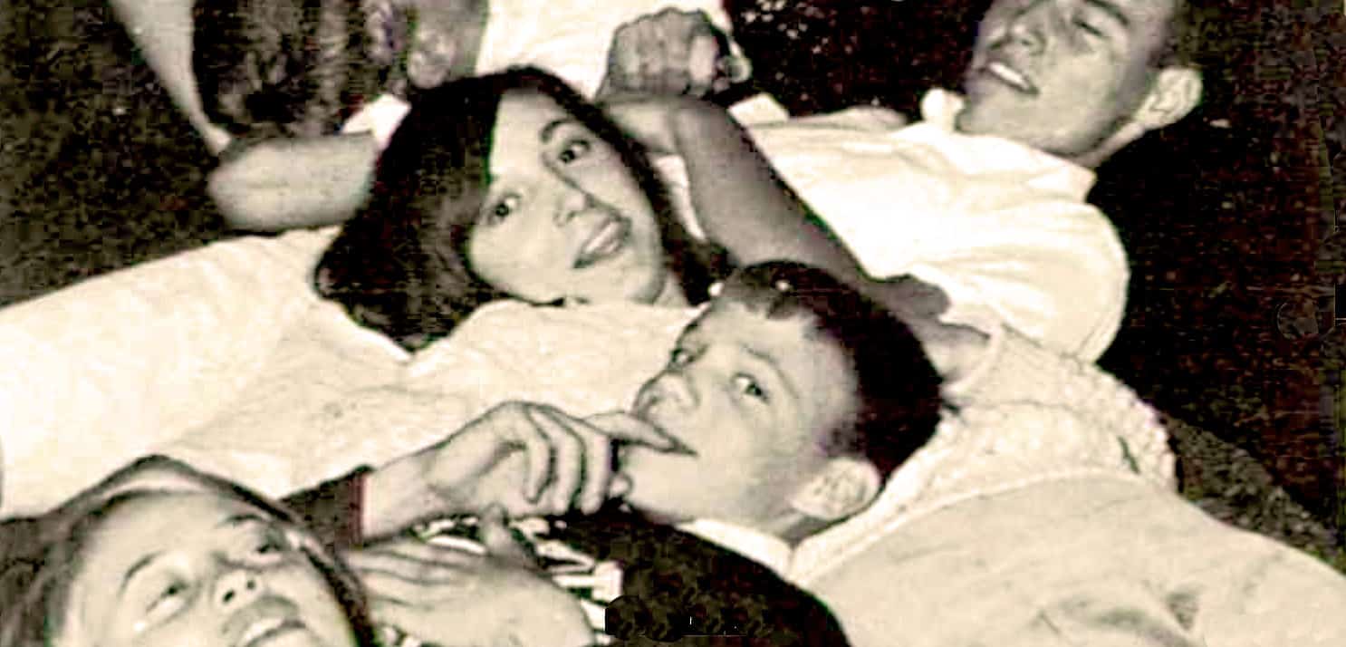 Girl and boy lying on bed, nostalgic vintage photo, classic Asian couple, traditional attire, black and white image, cultural heritage, romantic scene, early 20th-century style, historical photograph, timeless love story, future memories.