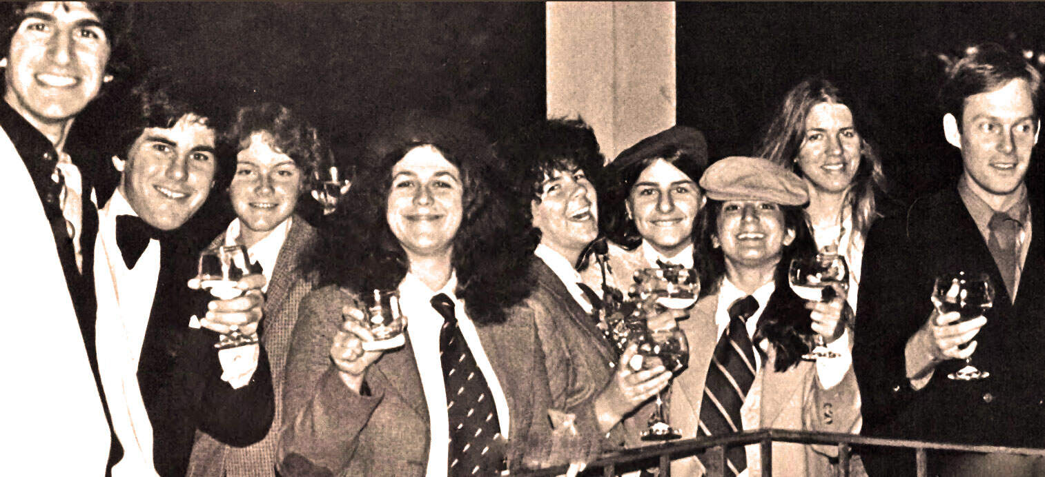 People at a celebration holding wine glasses, vintage black and white photo, social gathering, friends enjoying drinks, 1980s party, event atmosphere, historical social scene, nostalgic celebration, music and news archive.