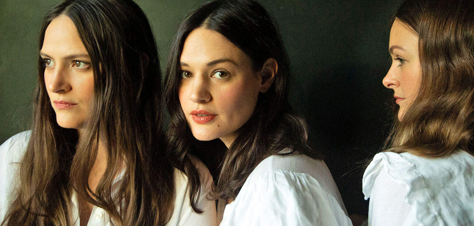 Past daily sound archive news history music women portrait, vintage photograph of three women with dark hair and white shirts, side profile and facing forward, professional studio photography, historical and cultural significance, entertainment and media preservation, female empowerment and storytelling, classic television and music history images.
