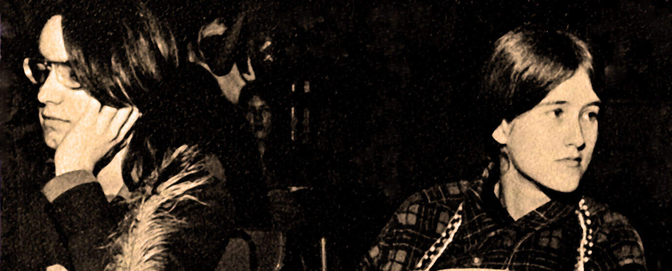 Vintage photograph of two women in a news and music radio archive setting, capturing moments of historical radio broadcasting and music preservation.