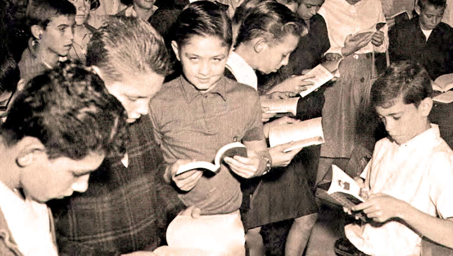 Children and teenagers reading books in a classroom or library setting, emphasizing education, learning, and youth literacy.