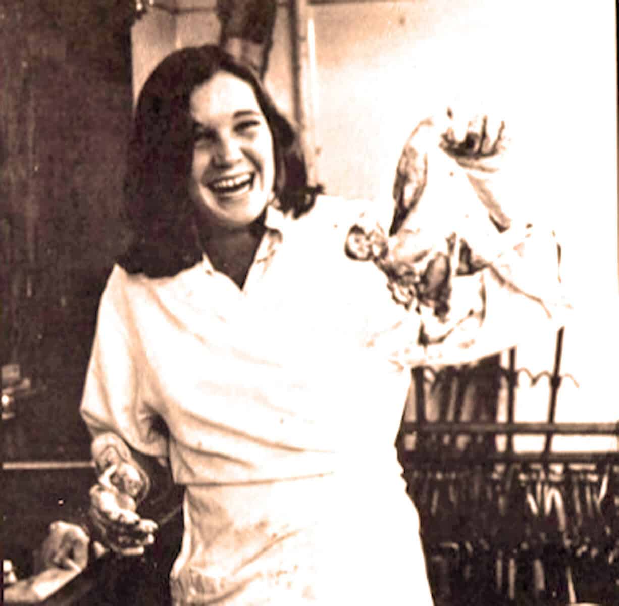 Vintage black and white photo of a woman holding a roasted turkey, celebrating a holiday with festive joy, reflecting a nostalgic moment in American history and tradition.