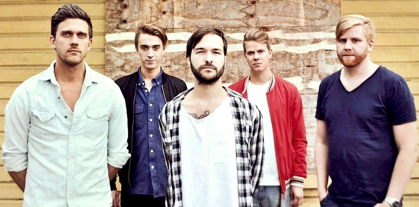 Vintage indie band photo with young men standing outdoors, showcasing a modern music scene, suitable for music archives, news, and history related to contemporary bands.