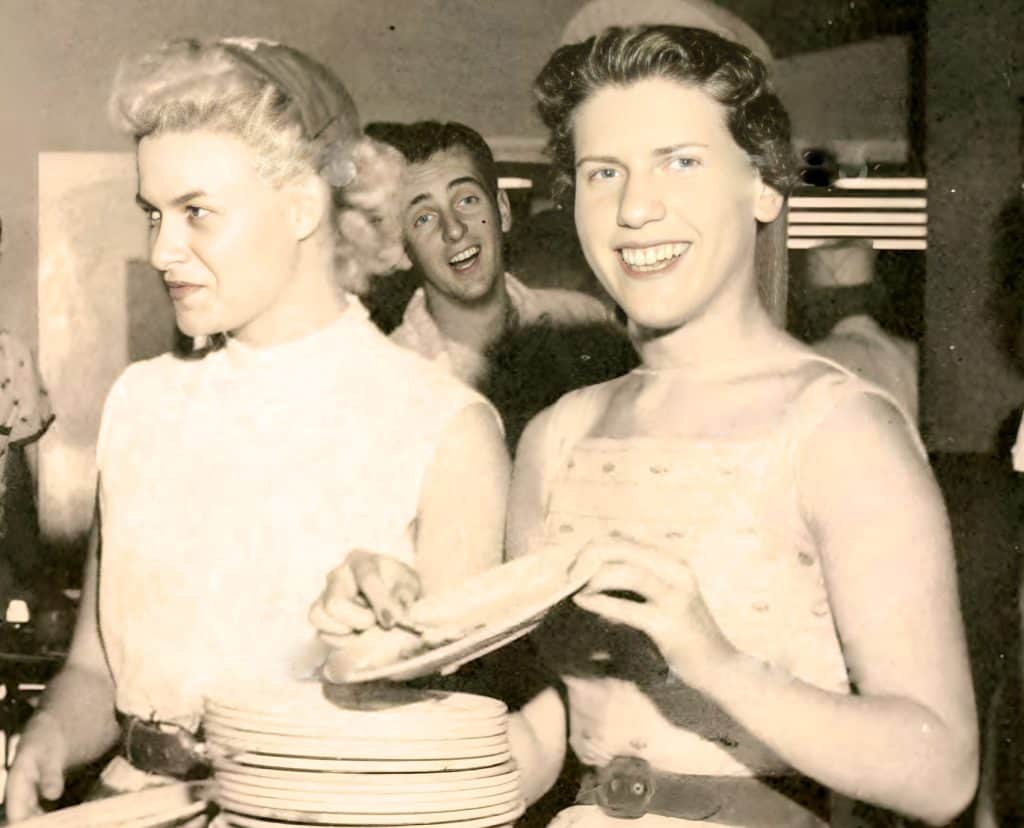 1930s vintage photo of women at a social gathering, showcasing classic fashion and hairstyles from the era. Emphasizes retro style, social events, and historical fashion, suitable for images about 20th-century culture.