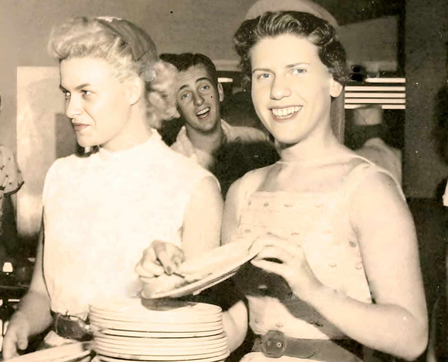 1930s vintage photo of women at a social gathering, showcasing classic fashion and hairstyles from the era. Emphasizes retro style, social events, and historical fashion, suitable for images about 20th-century culture.