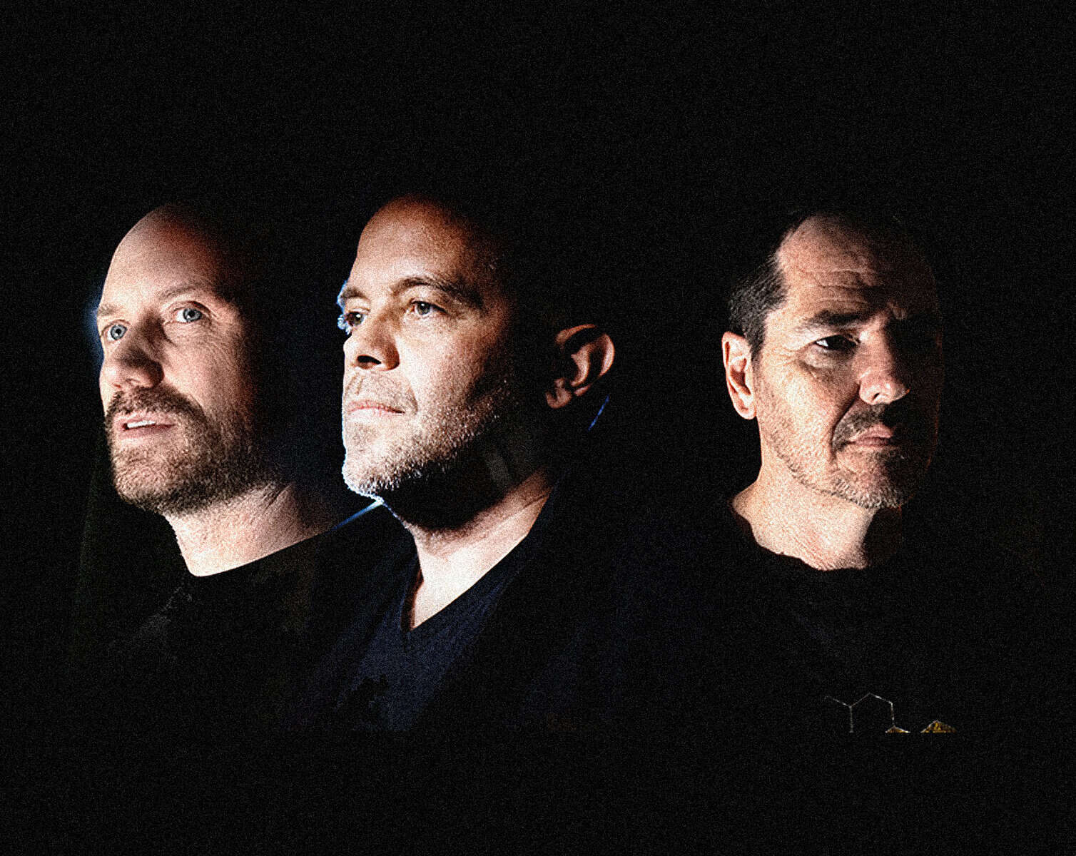 Bald man with beard, man with stubble, and man with mustache in a dark setting, showcasing influential figures in news, history, and music archives, representing Past Daily's comprehensive sound archive.