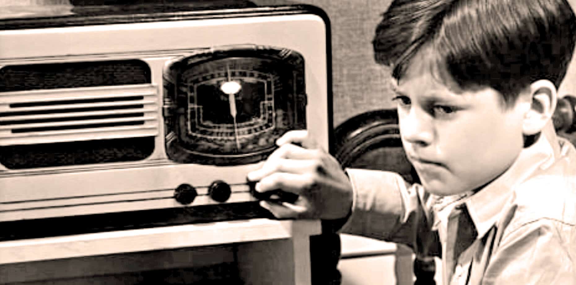 Child tuning vintage radio, nostalgic music and broadcast archive, historical sound recording from past daily news, history, and music collection.