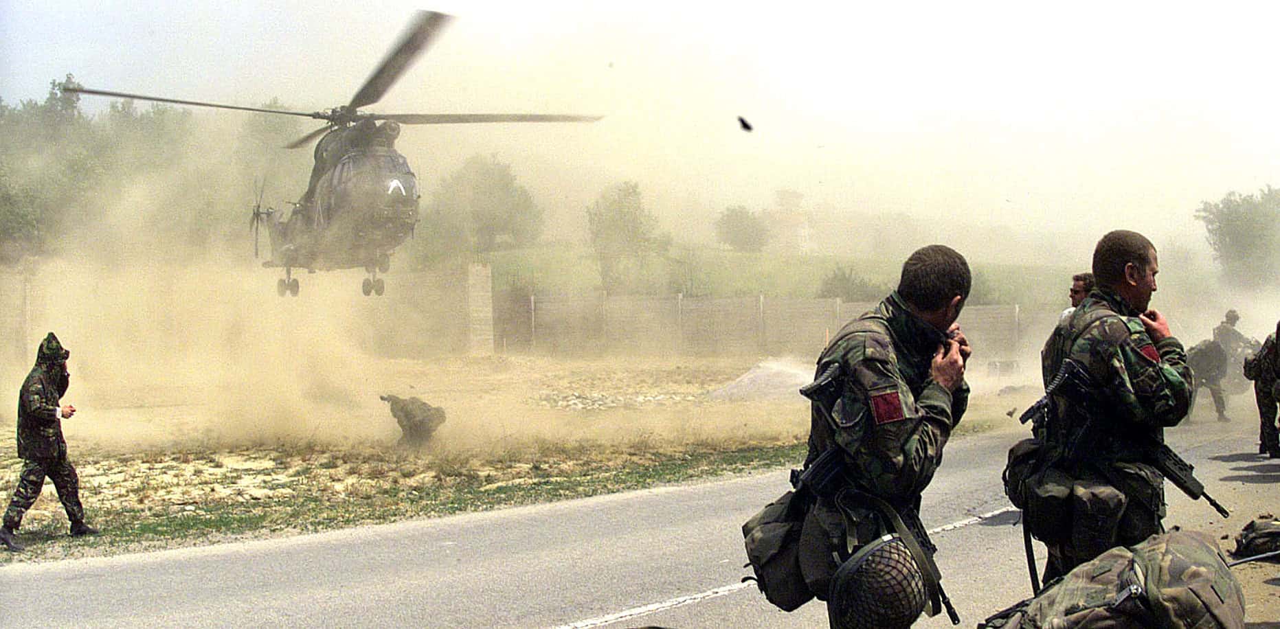 Helicopter landings and soldiers during a military operation, capturing historical wartime moments for news reporting and music archives.