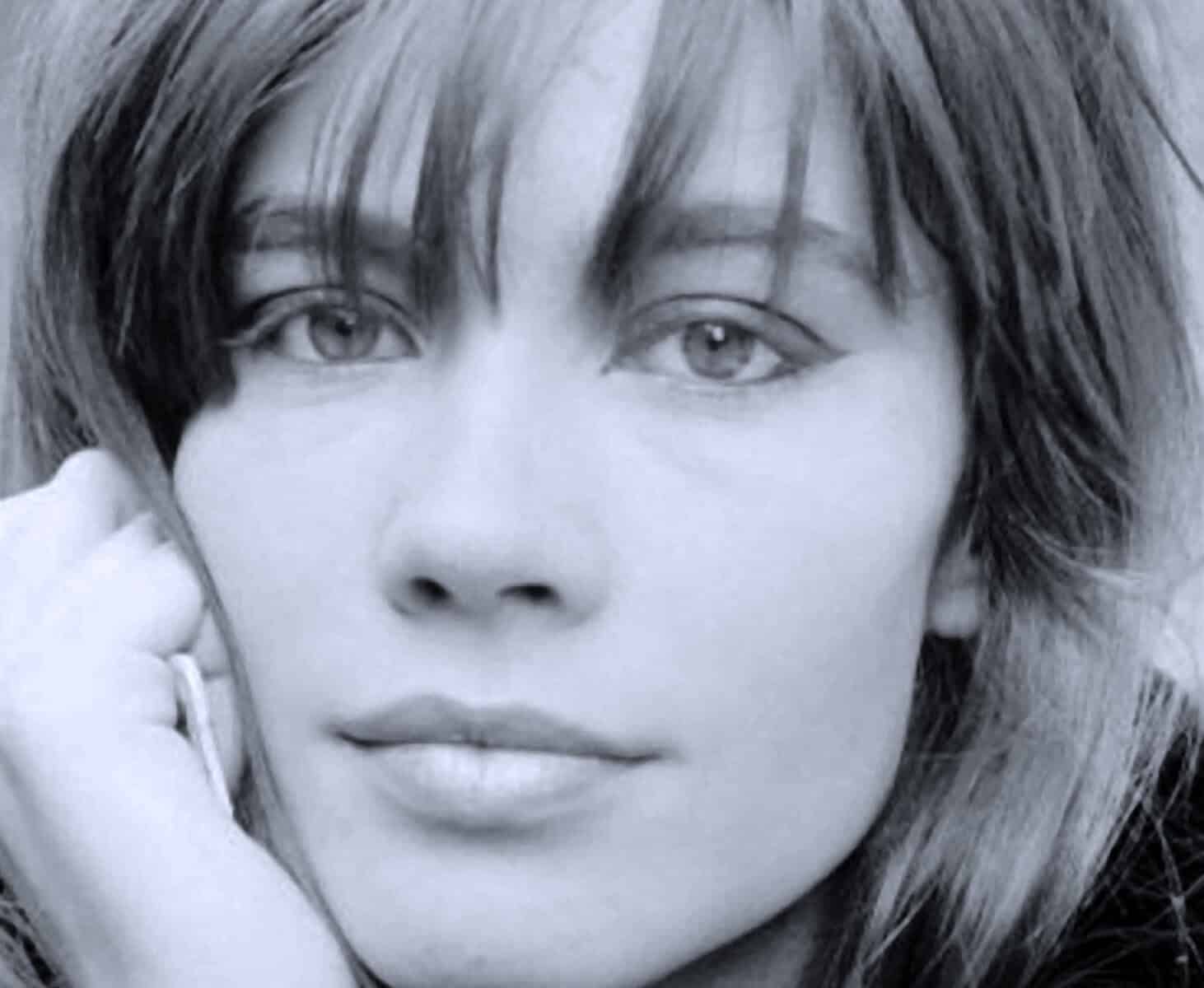 Close-up black and white portrait of a woman with short hair, emphasizing her expressive eyes and facial features, representing nostalgia, history, music, and news archival content.