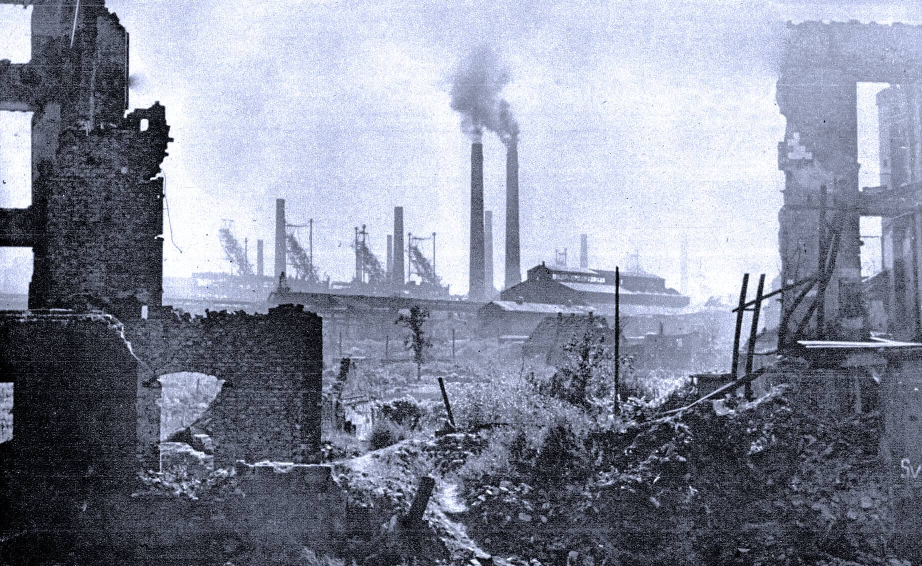 Ruined industrial cityscape with smoke billowing from chimneys, black and white historical photograph emphasizing war destruction and urban decay, capturing the aftermath of wartime devastation.