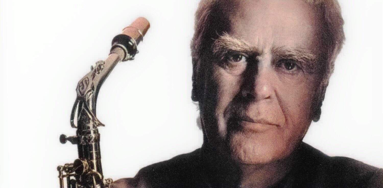 Vintage jazz saxophonist holding his instrument, representing classic music archive content on Past Daily.