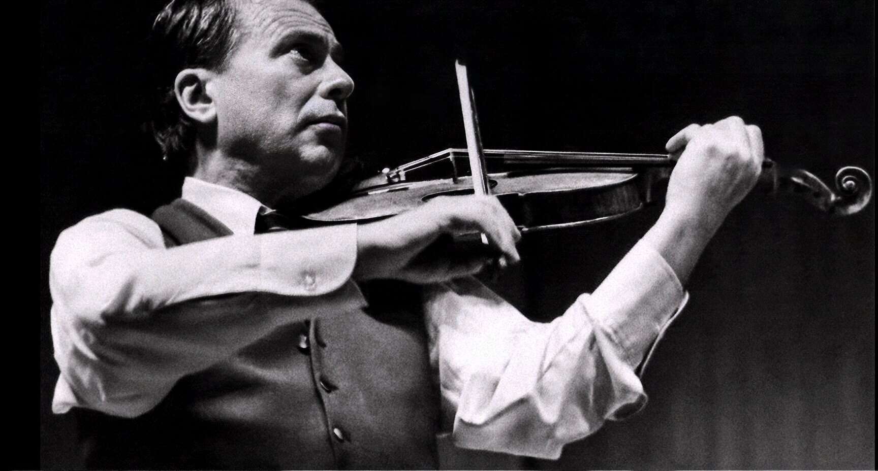 Classic black and white image of a male violinist performing, capturing the passion and intensity of live music, perfect for archives focusing on music history, performance art, and nostalgic visuals.