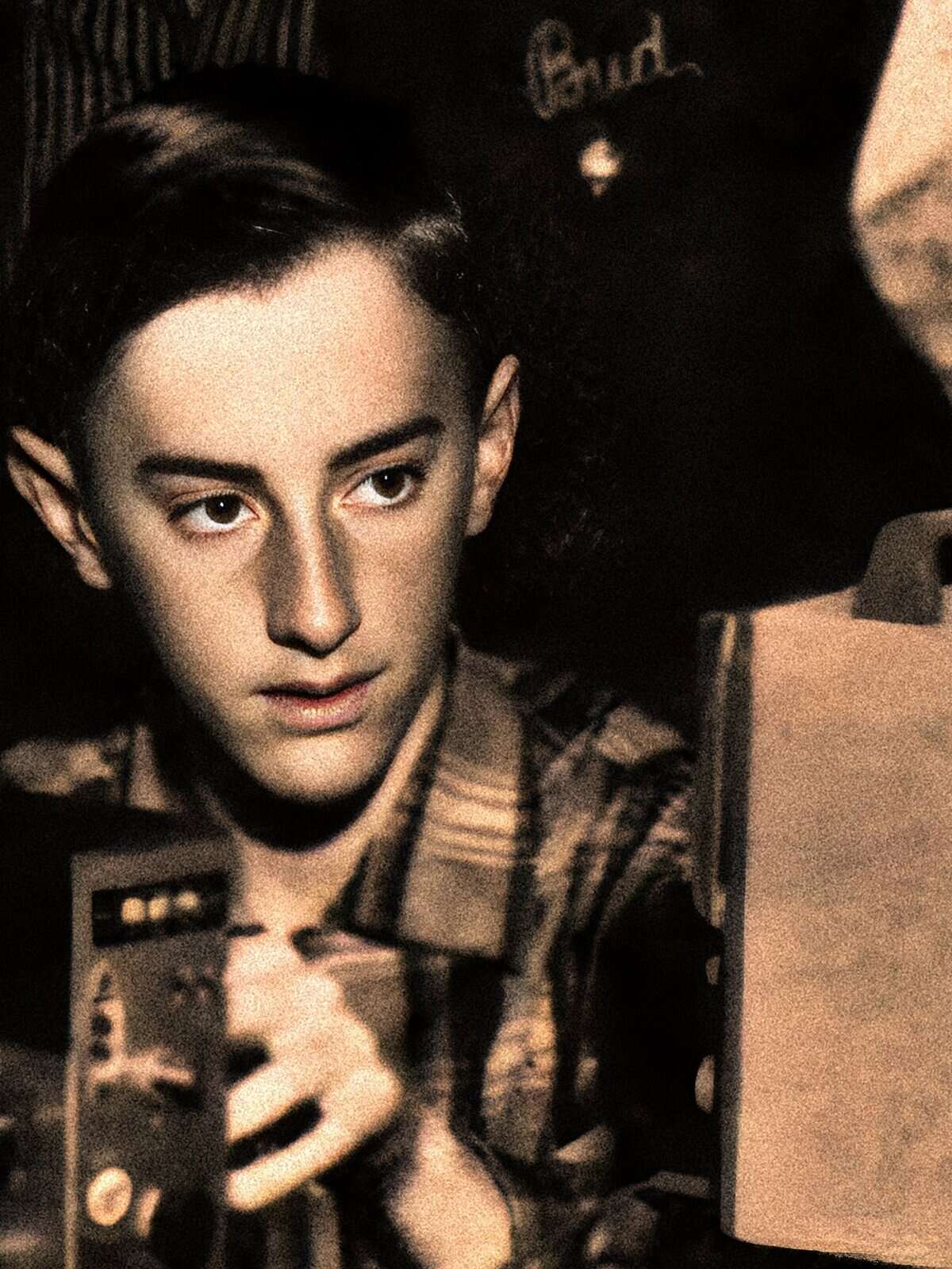 Man in military uniform operating a radio, from the movie "All Quiet on the Western Front".