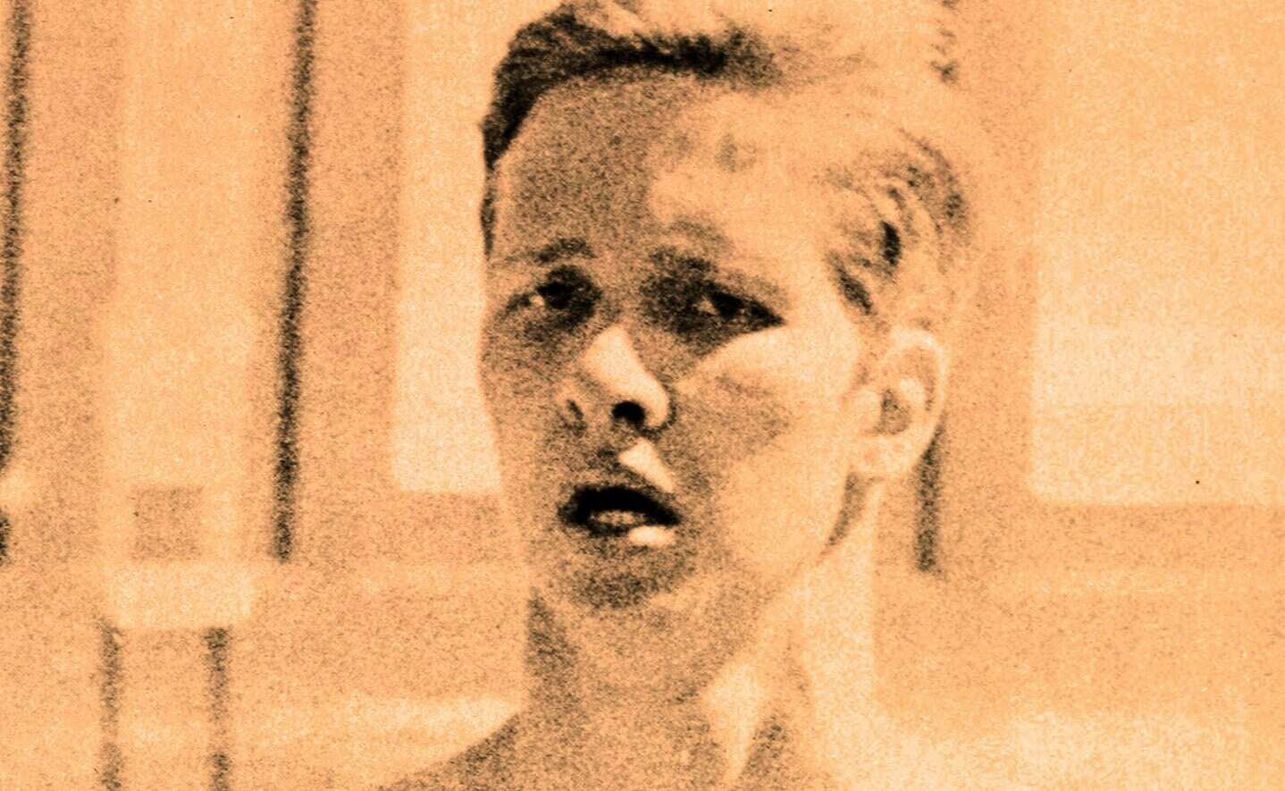 A vintage photo of a young woman with a surprised expression, emphasizing historical news, music, and sound archives from Past Daily.