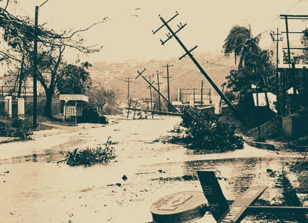Damaged power lines and debris in flood-affected area, emphasizing historical weather disasters and emergency response.
