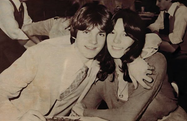 Dining couple vintage black and white photo, young man and woman smiling together, 1960s era, nostalgic music and history, social gathering, timeless relationship, retro style, classic photography.