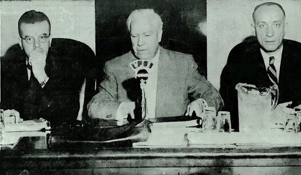 Archival black and white photo of three men at a news conference, possibly from a historic broadcast, representing a sound archive of news, history, and music.