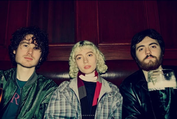 A Sound Archive of News, History, and Music featuring a vintage photograph of young musicians in a cozy, nostalgic setting, highlighting Past Daily's rich collection of historical audio recordings.