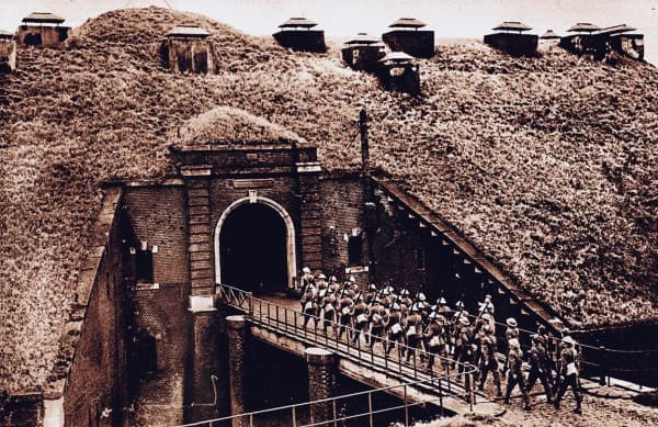 A historical underground bunker with soldiers marching through a tunnel, representing Cold War era military history and wartime archives.