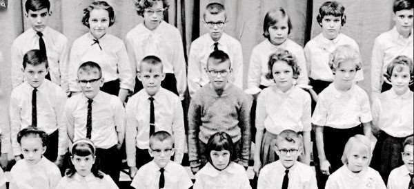 School children in uniform posing for a class photo, evoking nostalgia and historical education themes, perfect for a visual related to news archives and cultural history.