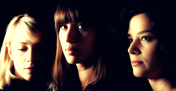 Vintage women listening to music with headphones, representing historical sound archives and music preservation at Past Daily.