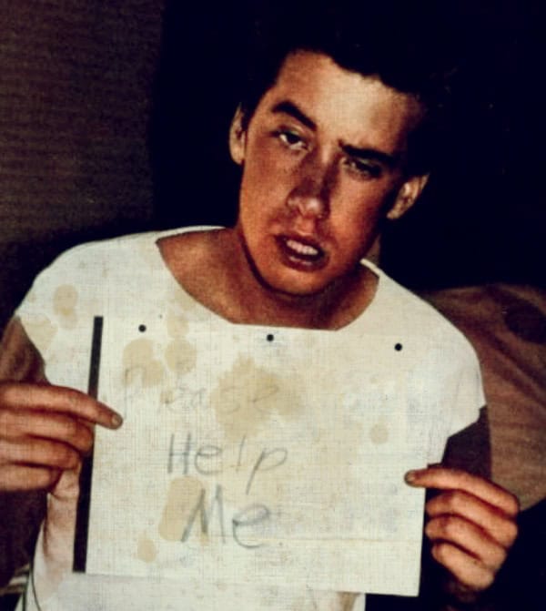 Help me sign up for the 1960s counterculture movement, capturing a rebellious youth holding a "Help Me" sign, representing social activism and music history in the era.