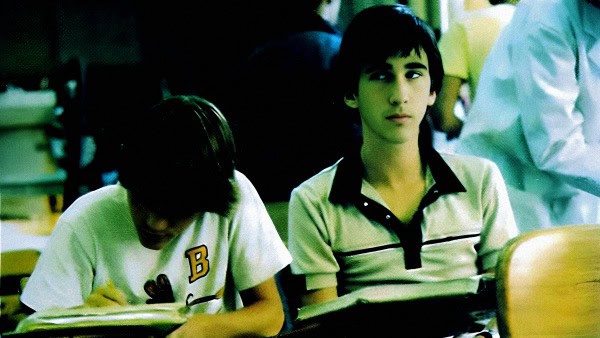 Student in classroom studying with educational materials, symbolizes learning and school environment.