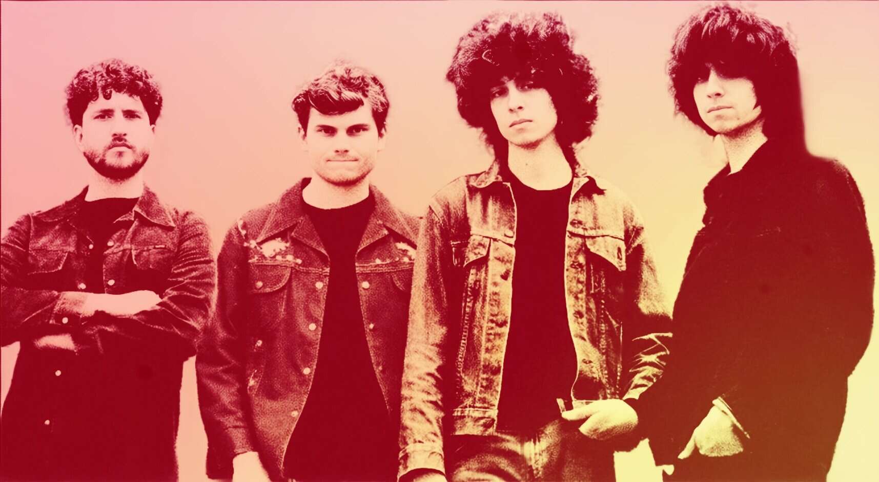 Young rock band members standing together, wearing denim jackets and casual attire, representing music history and the vibrant era of classic rock bands.