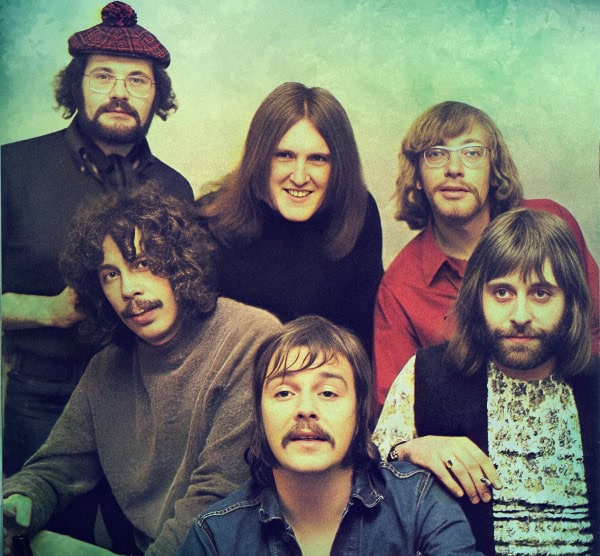Retro music band portrait featuring six members with vintage style, representing classic rock era, ideal for music history and nostalgic music archive content.