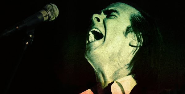 Microphone and singer passionately performing live on stage, music performance, vocal artist, concert, entertainment, dynamic music scene.