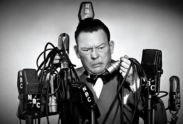 Microphone cluttered with wires at a vintage radio station, black and white, nostalgic radio broadcast equipment, historical sound archive, iconic broadcast from the past.
