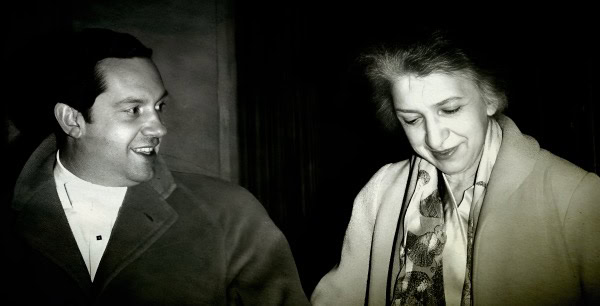 Black and white photo of a smiling man and woman engaged in conversation, capturing a moment of social interaction at Past Daily Sound Archive event.