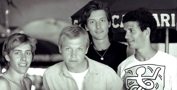 Past daily sound archive of news music and history, vintage photo of a boy band, youthful musicians, 1990s pop music, nostalgic era, group of four young men, concert scene, musical reunion, archived historical images, classic music culture, entertainment history.