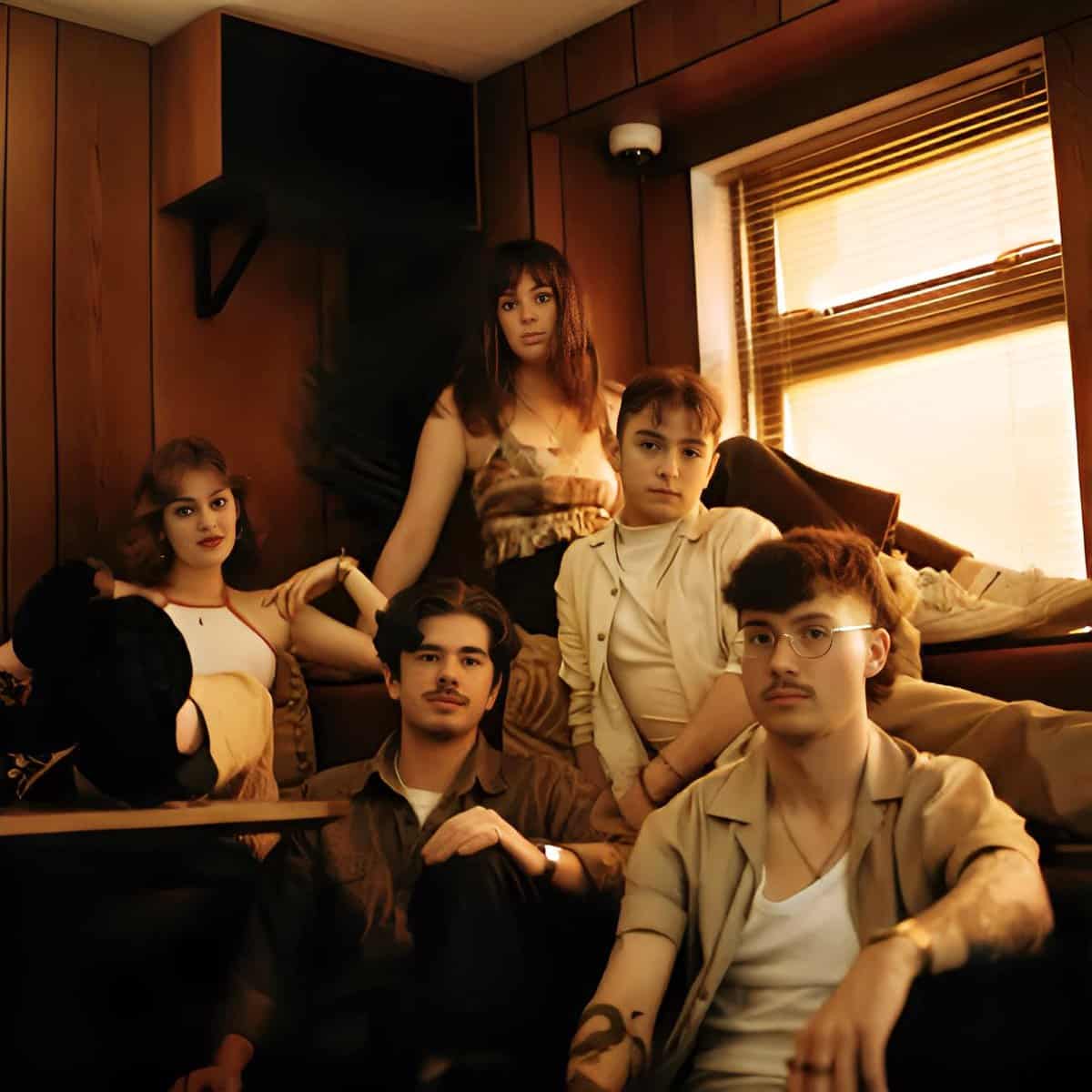 Journalists working in a cozy, wood-paneled radio studio, capturing vintage music and news archives for preservation, with warm natural light from a window illuminating the scene.
