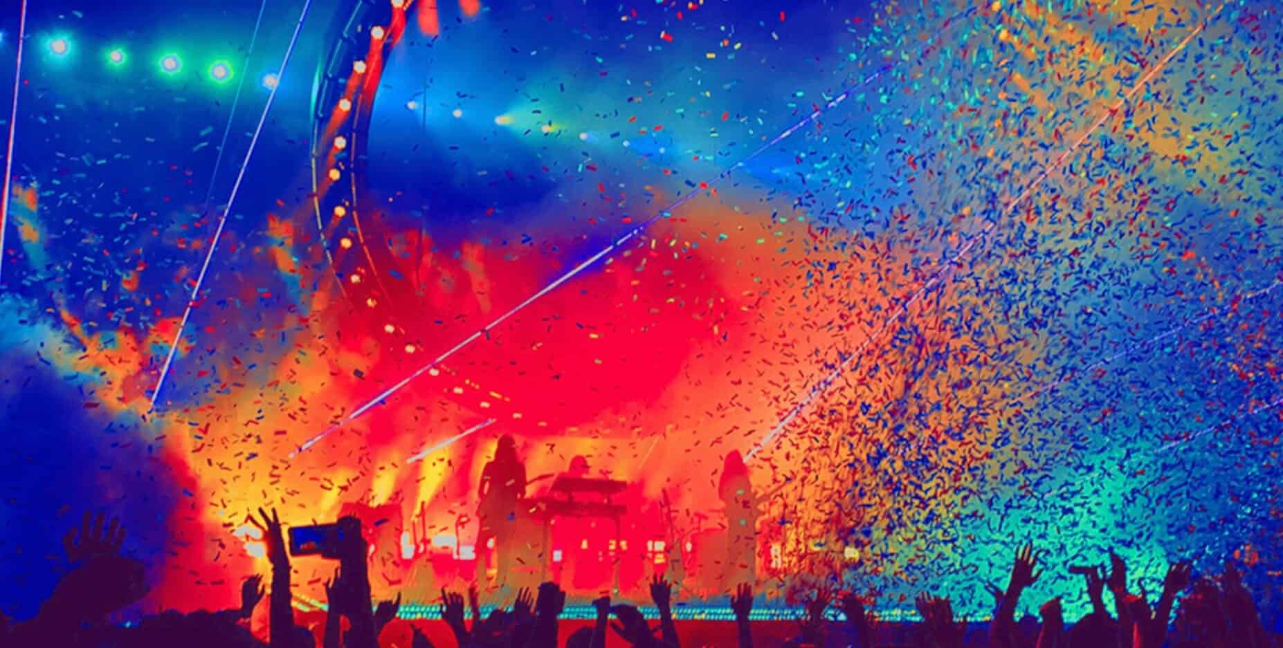 Colorful concert stage with confetti, laser lights, and silhouetted audience at a live music event for nostalgic news, history, and music archive imagery.