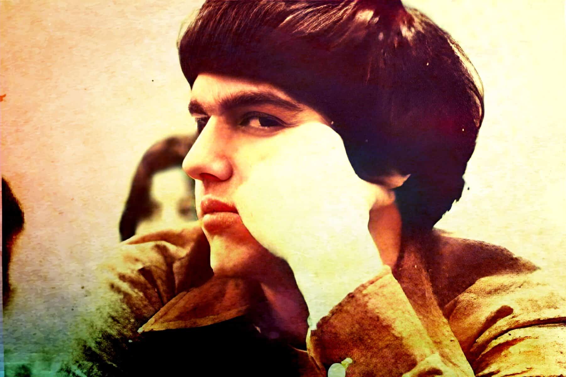 Vintage photo of a young man with dark hair, showcasing classic 1960s style, possibly connected to music, news, or cultural history archives on Past Daily.