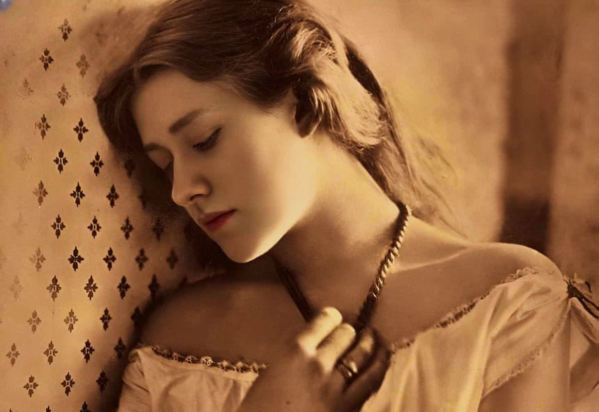 Vintage woman with closed eyes leaning against patterned wall, nostalgic atmosphere, sepia tone, soft lighting, historical portrait, emotional mood, timeless beauty, classic style, elegant clothing.
