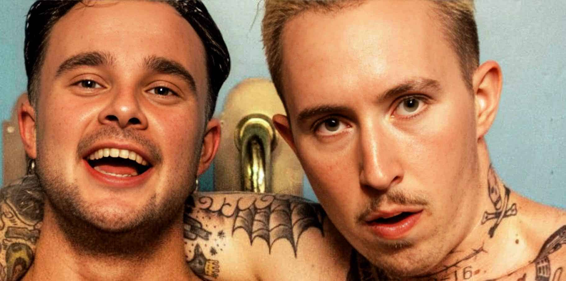 Close-up of two young men with tattoos, expressive faces, and vibrant personalities, showcasing music, news, and cultural history from Past Daily's sound archive.