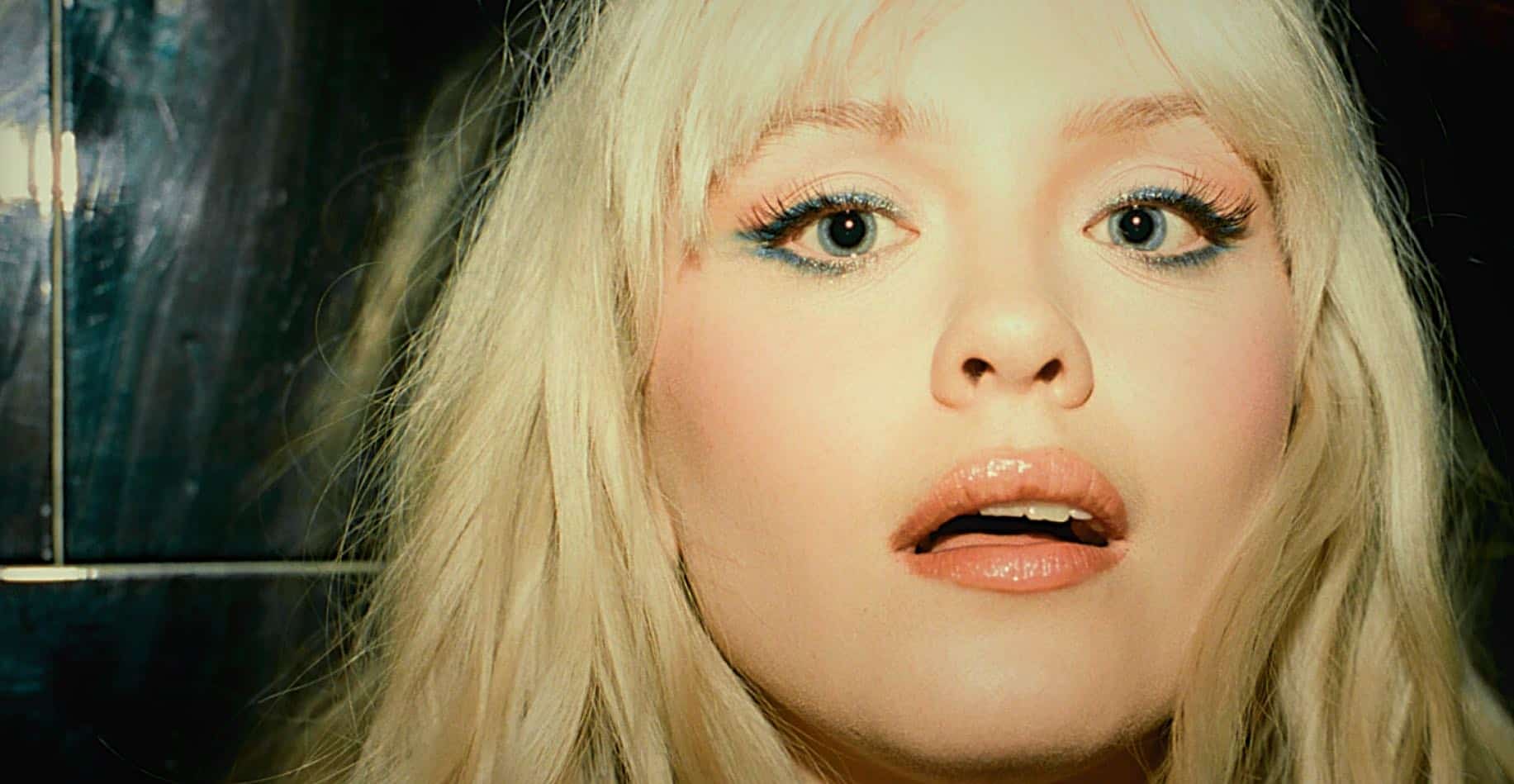 Bright blonde woman with blue eye makeup, close-up portrait for music, news, and entertainment archive.