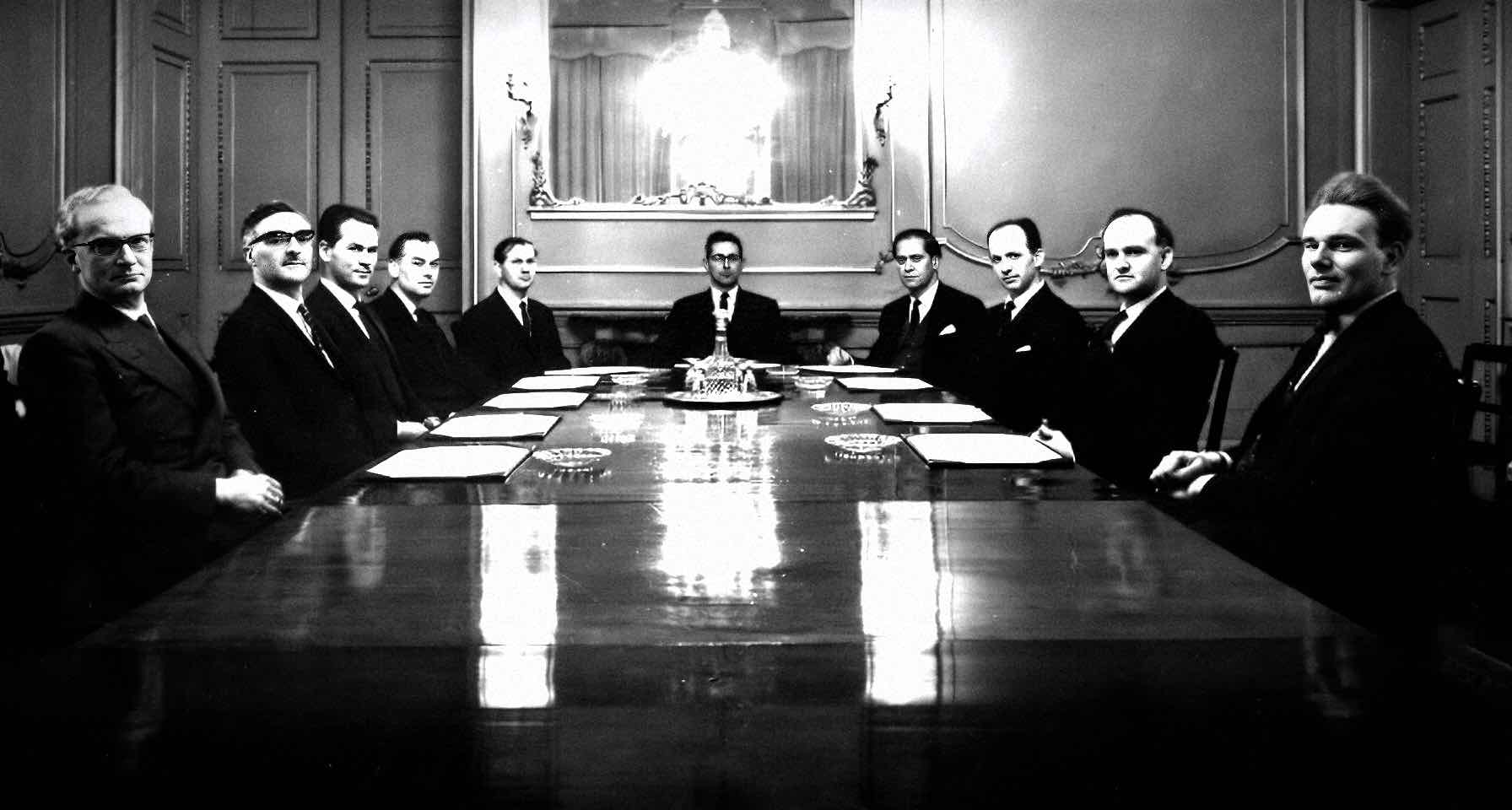 SNAPSHOT OF A HISTORIC MEETING WITH NEWS, HISTORY, AND MUSIC ARCHIVES - The image features a formal meeting in an elegant, vintage conference room, emphasizing the preservation of news, historical moments, and music archives for educational and cultural research.