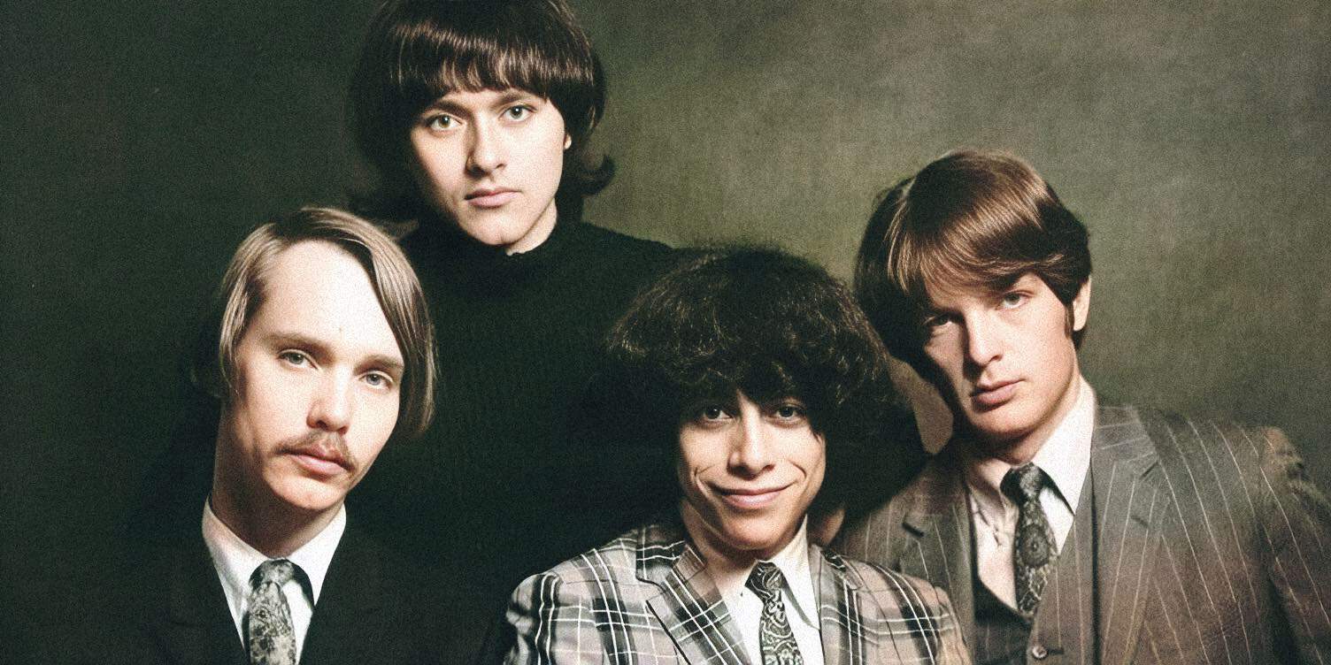 Vintage British rock band The Monkees, displaying classic 1960s style, in a promotional photo showcasing their music and cultural impact.