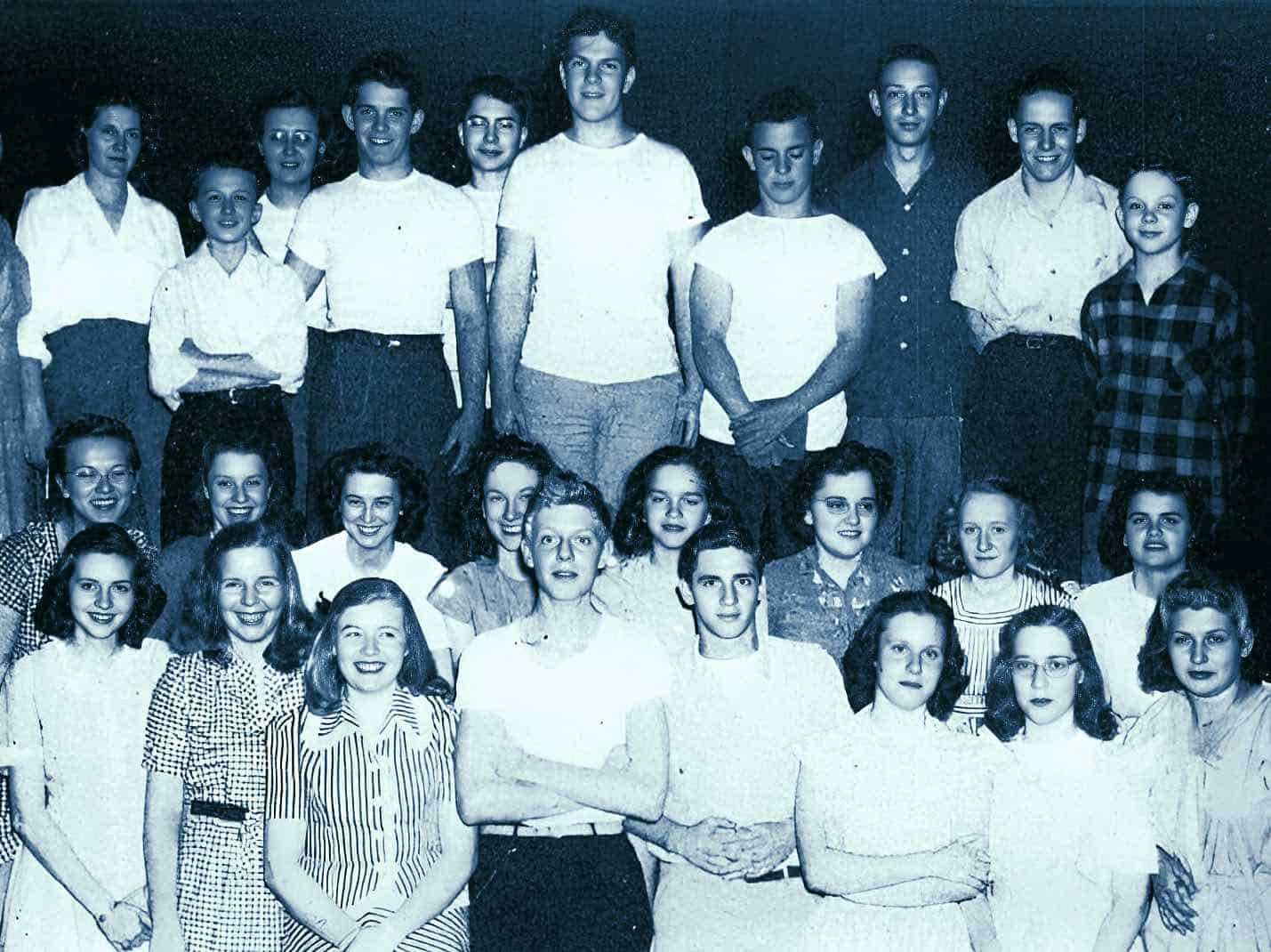 Vintage black and white group photo of men, women, and children, highlighting social history, community, and historical photo archives.