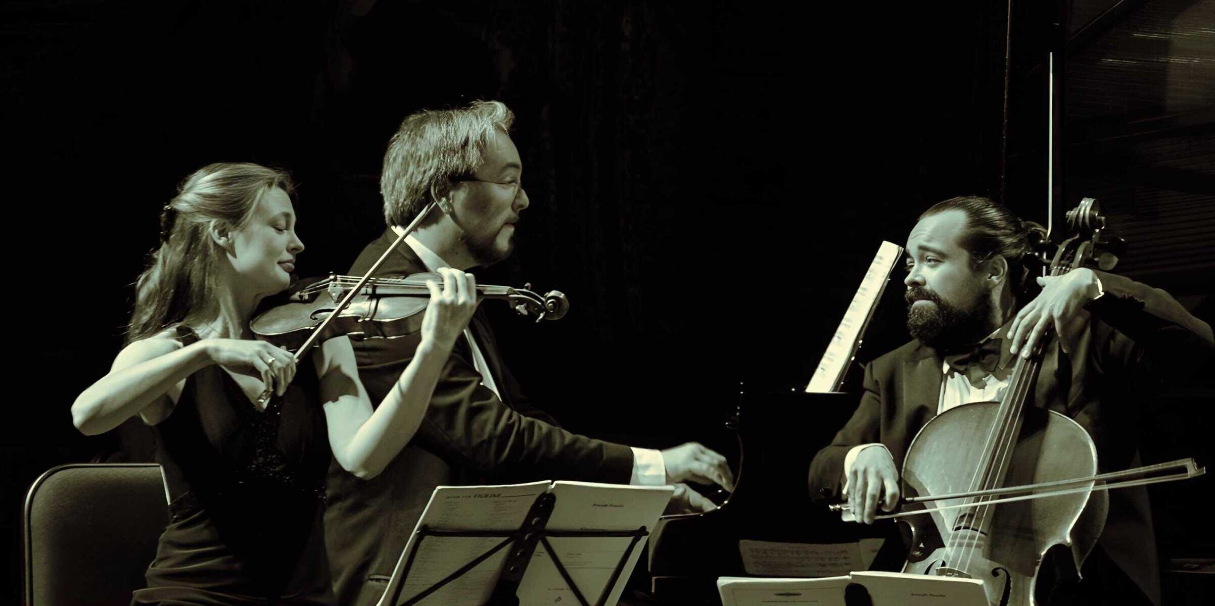 Vintage classical music performance featuring string musicians and a pianist, showcasing a live orchestral concert with focus on art, culture, and musical heritage.