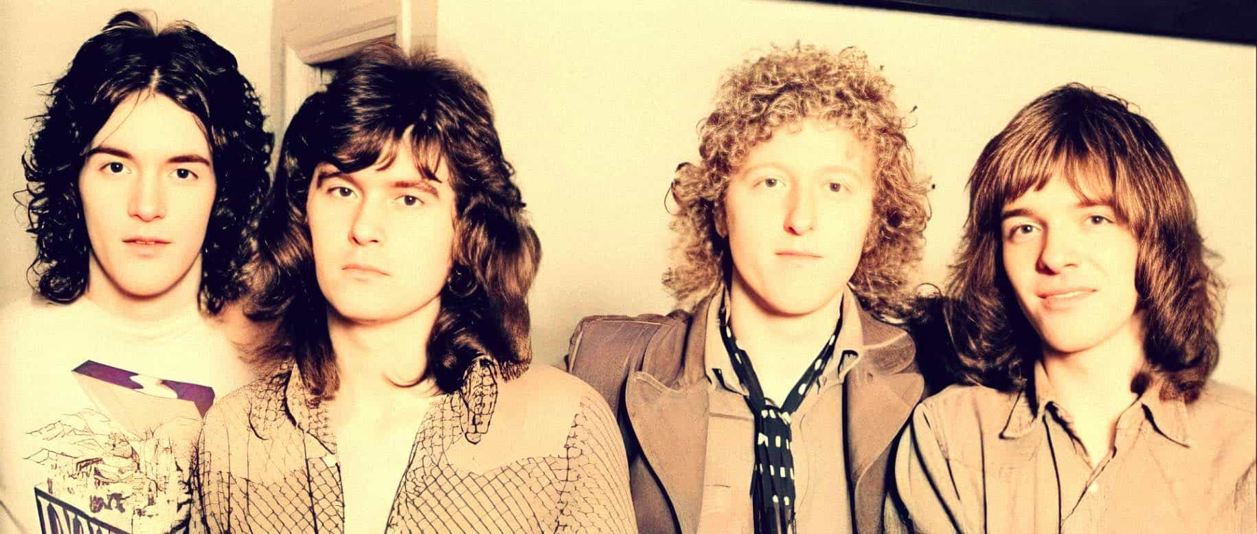 British rock band member portrait, 1970s Beatles tribute band, vintage music band photo, classic rock musicians, iconic 70s band image for past daily history and music archive.