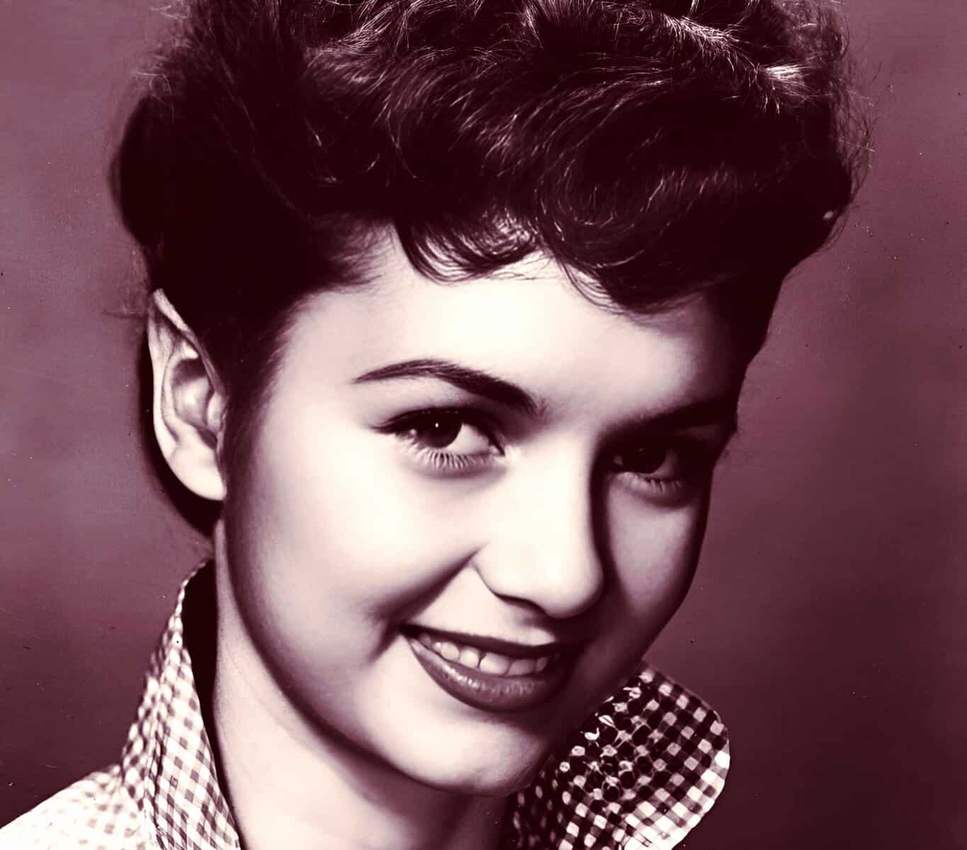 Vintage black and white photo of a young woman with short, styled hair, representing history and cultural nostalgia, perfect for a sound archive of music, news, and history.