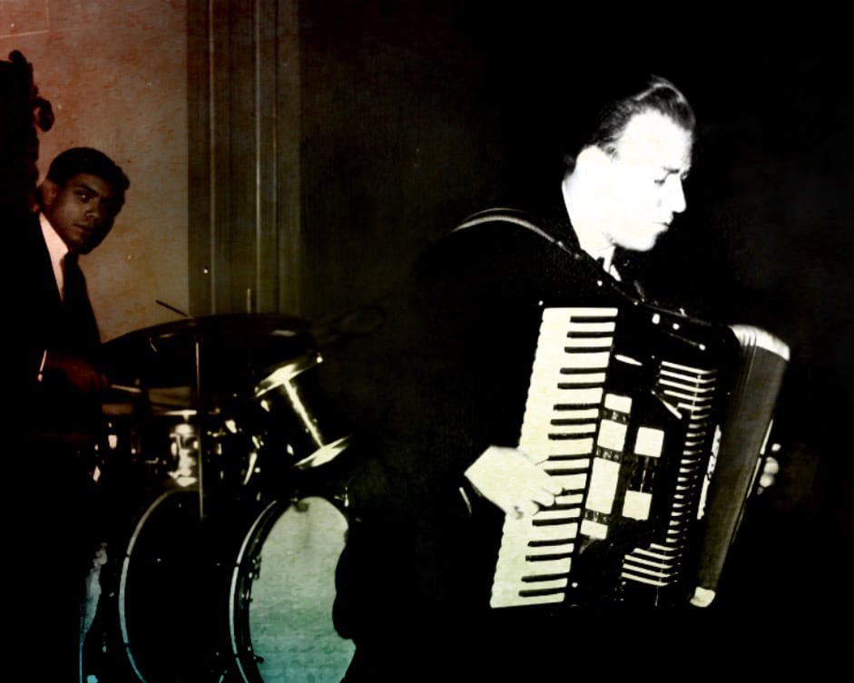 Drummer and accordionist performing live jazz music in a vintage setting, black and white photo, historic music performance scene, classic jazz musicians, archive image of live musical performance.