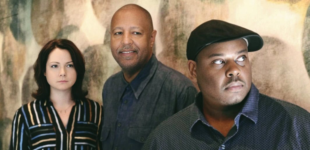 African American music band members posing for promotional photo highlighting jazz and blues history.